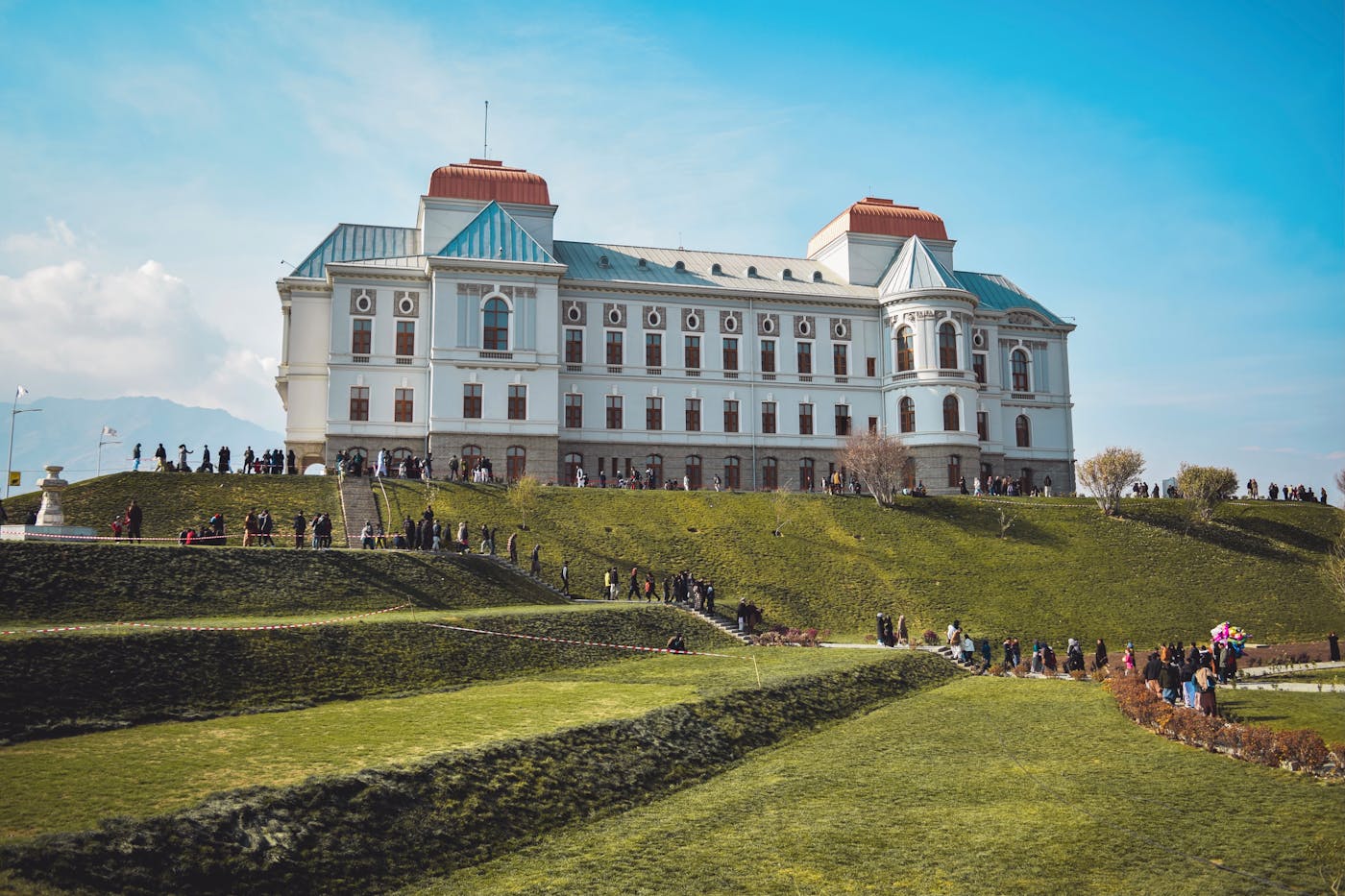 Darul Aman Palace on a terraced green hill in Kabul — national heritage and public institutional presence.